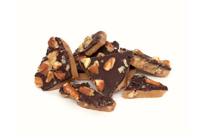Close up picture of toffee covered in pecans and dark chocolate